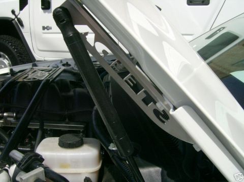 2007 Ford Mustang - Custom metal plate with 'JET 2' lettering is visible in the engine bay of a white vehicle, with another white vehicle in the background.