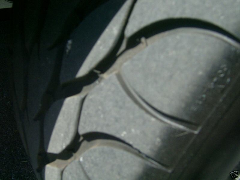 Close-up of directional performance tire tread showing wear