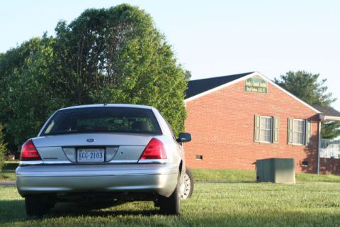 2004 Ford Crown Victoria - Rear view of a silver Ford Crown Victoria parked on a grassy lawn.