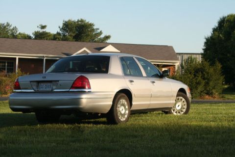 2004 Ford Crown Victoria - This 2004 Ford Crown Victoria is seen from the rear, parked on a grassy lawn in front of a house.