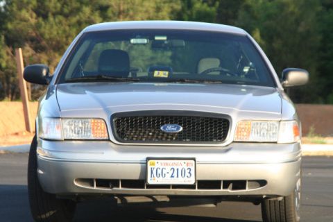 2004 Ford Crown Victoria - Front view of a silver 2004 Ford Crown Victoria, its distinctive grille and headlights.
