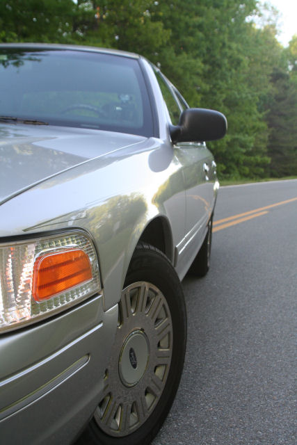 2004 Ford Crown Victoria - Silver 2004 Ford Crown Victoria parked on the side of a road.