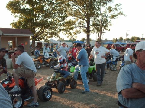 1995 Ford Probe - Spectators and participants mingle around ATVs at an outdoor event, with tents and trees visible.