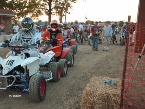 1995 Ford Probe - Quads and riders are lined up, possibly for a race, with the number 116 prominently displayed on the front quad.