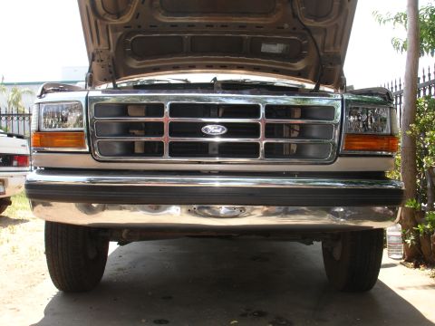 1992 Ford F-350 - The front grille and headlights of a 1992 Ford F-350 are visible with the hood open.