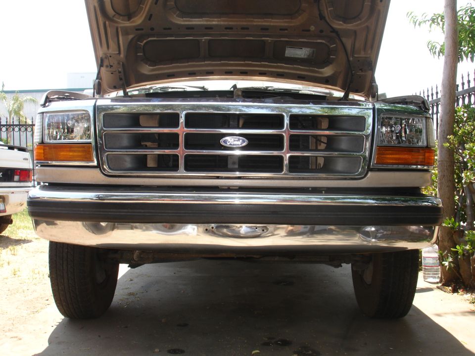 Front view of a 1992 Ford F-350 with hood open. Shows grille, headlights, and bumper