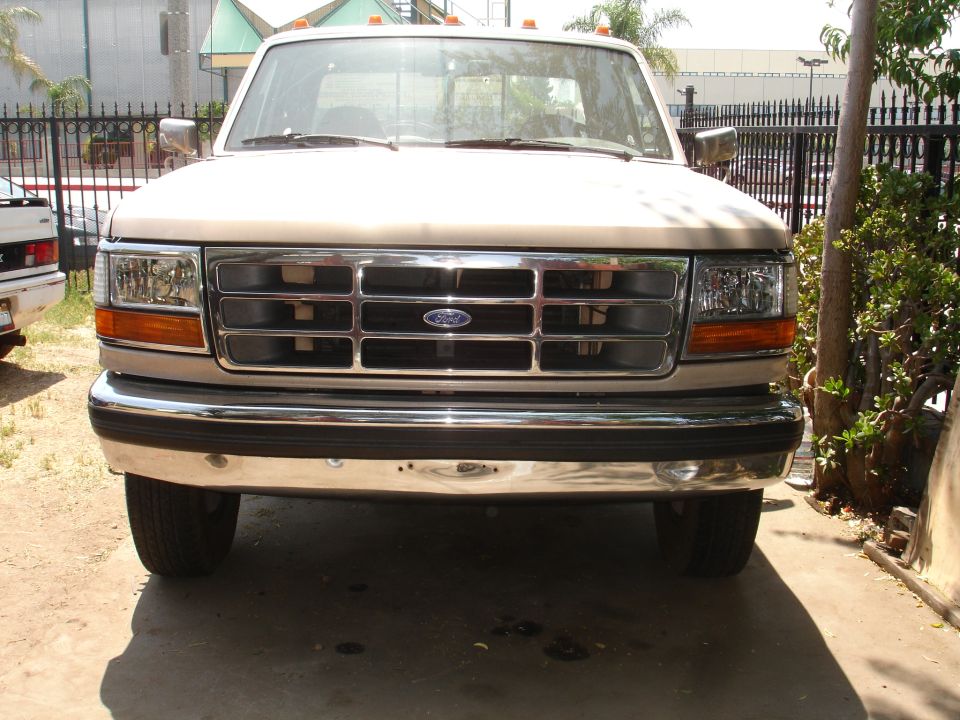 Front view of a tan 1992 Ford F-350 pickup truck with a chrome grille and bumper