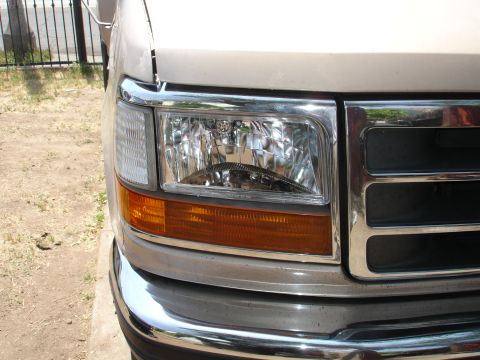 1992 Ford F-350 - Close-up of the front headlight and grille on a 1992 Ford F-350 truck.