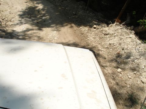 1989 Ford Bronco - Driving on a dusty dirt road, view from the hood of the vehicle.