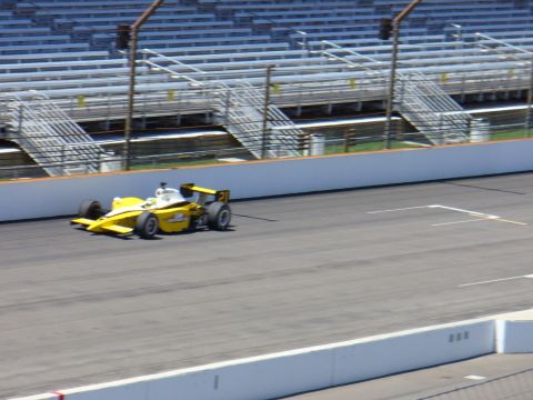 1991 Ford Probe - A single-seater race car speeds along the track, with empty spectator stands visible.