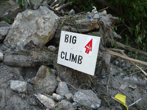 1989 Ford Bronco - A sign indicating 'BIG CLIMB' is placed amidst debris and rocks.