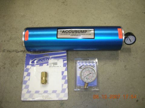 1996 Ford Bronco - Accusump oil accumulator with gauge and a brass fitting, likely for sale.