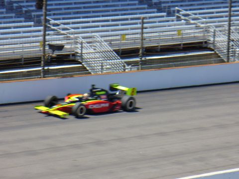 1991 Ford Probe - An open-wheel race car with 'DELPHI' visible on its side speeds around a track with grandstands in the background.
