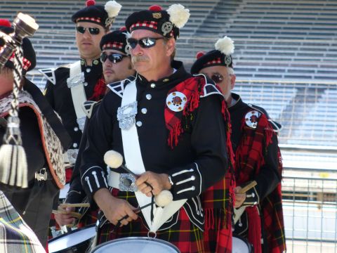 1991 Ford Probe - A group of drummers in kilts and ceremonial jackets are lined up, ready to perform.