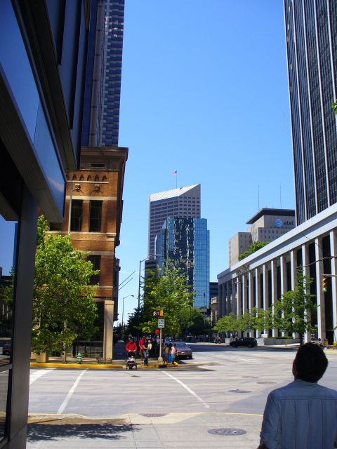 1991 Ford Probe - A view of a city street with modern architecture and a clear blue sky overhead.