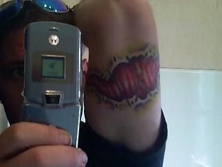 1993 Ford Bronco - A person displays a flip phone and a graphic tattoo on their arm.