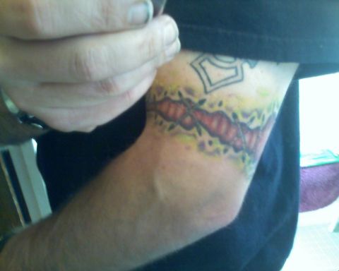 1993 Ford Bronco - A tattoo barbed wire and leaves is visible on a person's arm.