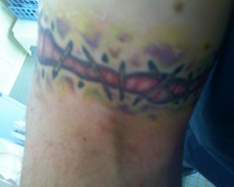 1993 Ford Bronco - Close-up of a barbed wire tattoo on a person's arm.