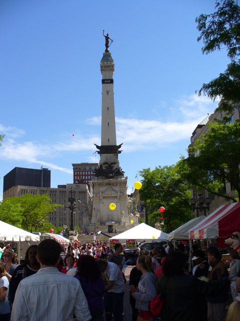 1991 Ford Probe - A bustling outdoor event takes place in a city square, with a prominent monument and many people gathered.