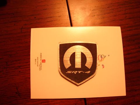 1996 Ford Probe - A Mopar SRT-4 badge is placed on a white card with text and decorative elements.
