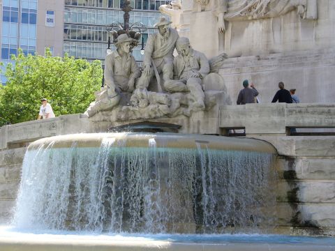 1991 Ford Probe - A large fountain features stone statues of men, with water cascading over its rim.
