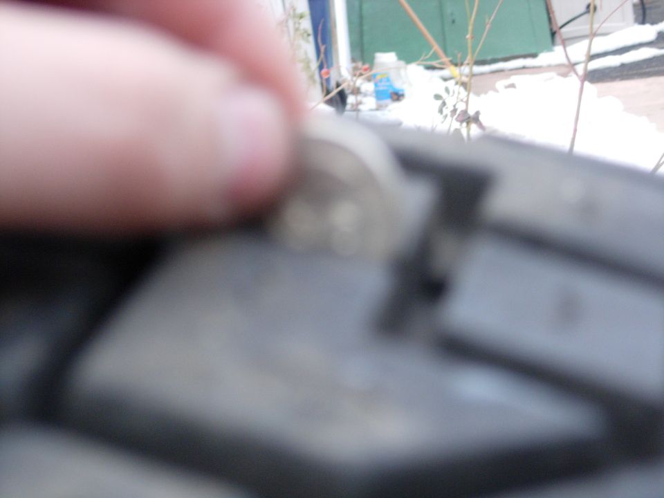 Coin resting on a tire tread