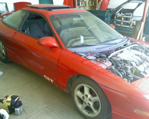 1993 Ford Probe - This 1993 Ford Probe GT is in a garage with its hood up, revealing the engine compartment.