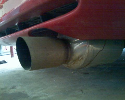 1993 Ford Probe - Close-up of a vehicle's exhaust pipe and lower rear bodywork.