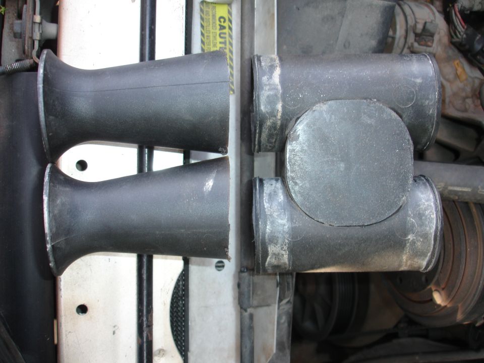 Two black intake pipes with flared ends and a T-junction pipe assembly
