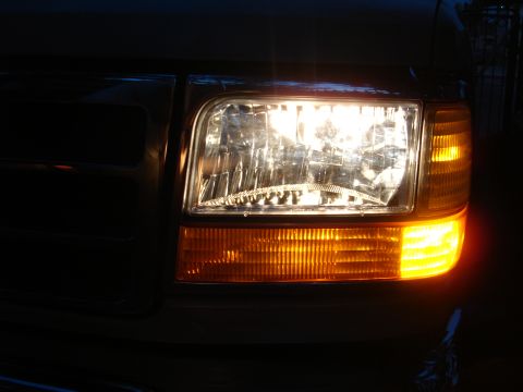 1992 Ford F-350 - Close-up of the driver's side headlight and turn signal assembly on a 1992 Ford F-350.