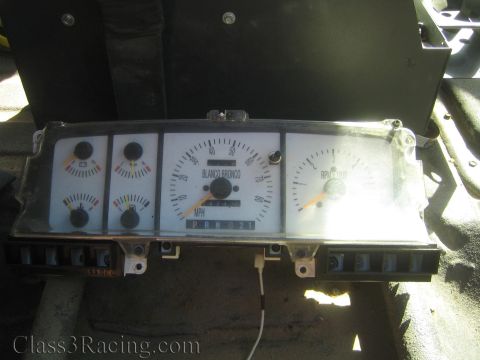 1990 Ford Bronco - removed vehicle instrument cluster with round gauges and a speedometer face labeled Blanco Bronco.