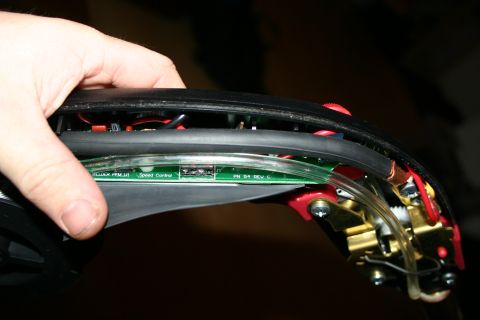 2003 Jeep TJ - Close-up of an electronic circuit board with visible wires and components, held by a person's hand.
