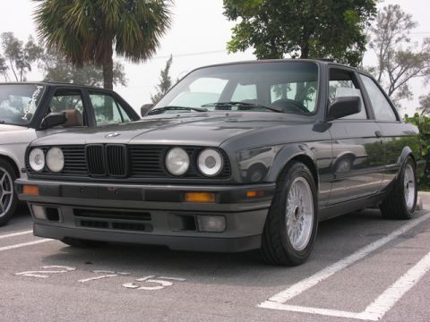 1989 BMW 3 Series - A dark gray 1989 BMW 3 Series coupe is parked next to another car.