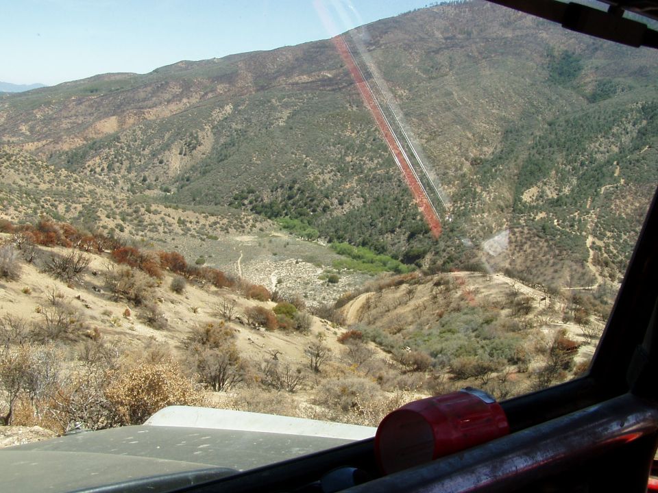 Interior view of off-road vehicle driving through a dry, hilly landscape