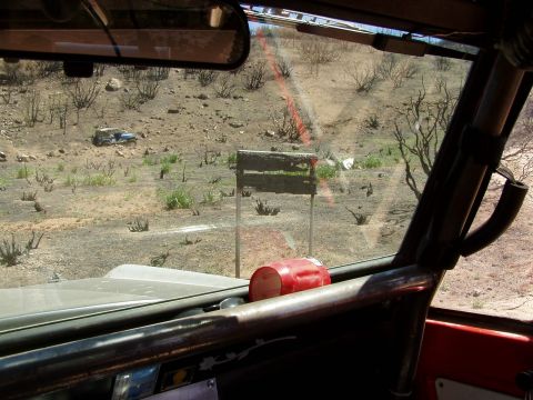 1967 Ford Bronco - Two off-road vehicles are seen in a dry, scrubby landscape, one in the distance and distance and one in the distance.