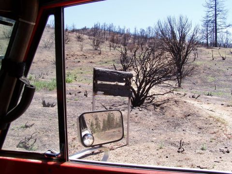 1967 Ford Bronco - The aftermath of a fire is visible in the dry, barren landscape.