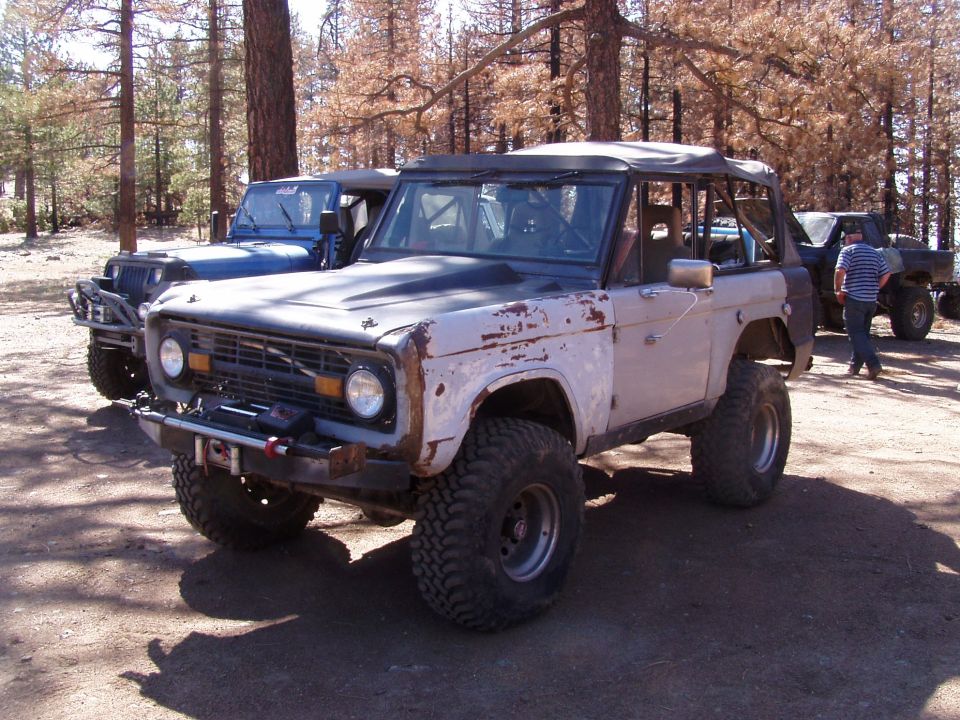 1967 Ford Bronco, light purple with black hood, off-road tires, parked outdoors