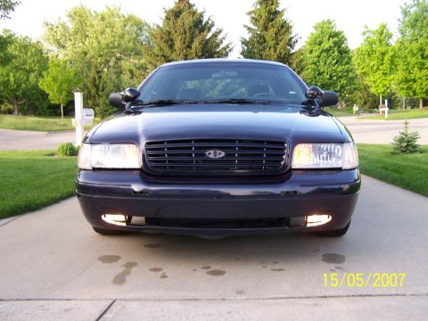 2003 Ford Crown Victoria - Front view of a dark blue 2003 Ford Crown Victoria parked on a driveway.