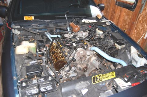 1985 Mercury Grand Marquis - The engine bay of a vehicle is shown with various mechanical components and a "Competition Engineering" sticker.