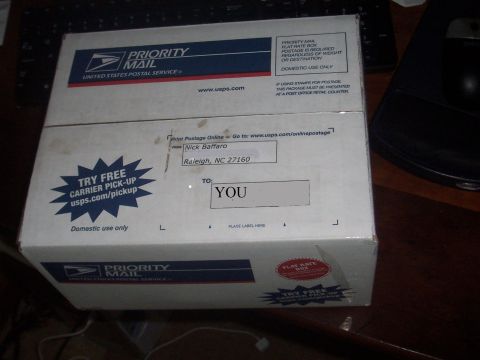 1979 Ford Bronco - A USPS Priority Mail box is shown with shipping information and a 'Try Free Carrier Pick-Up' sticker.