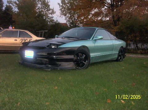 1901 Honda Odyssey - A modified Ford Probe is parked on grass with another car in the background. The date 11/02/2005 is visible.