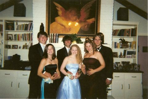 1995 Ford Bronco - A group of friends dressed in formal attire pose for a picture in a room with a large painting and bookshelves.
