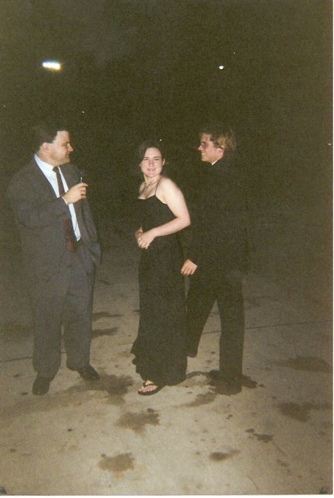 1995 Ford Bronco - Three people in formal attire stand together outdoors at night, with a website watermark visible.