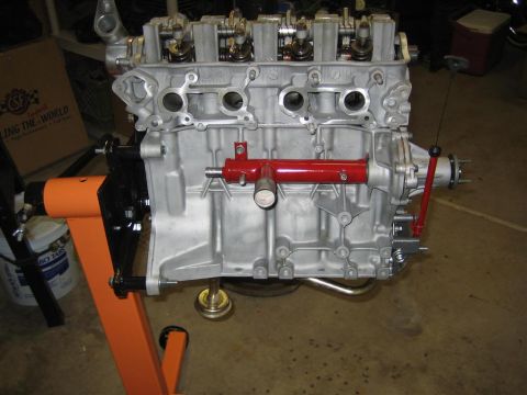 1987 Suzuki Samurai - Engine block mounted on an orange engine stand, ready for work.