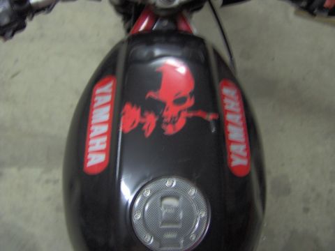 1993 Yamaha Seca II - The fuel tank of a motorcycle features prominent red Yamaha logos and a striking red skull graphic.