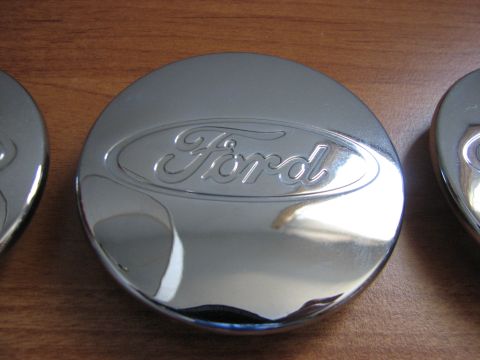 2003 Ford Crown Victoria - A close-up view of a chrome Ford hubcap, showing the embossed Ford logo.