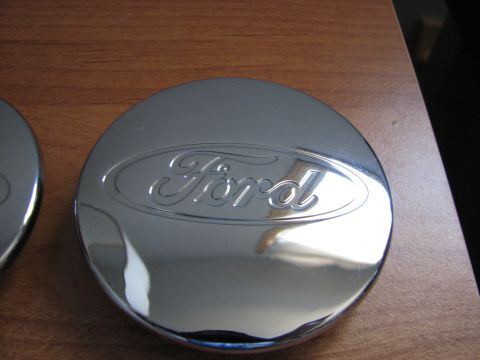 2003 Ford Crown Victoria - Close-up of a chrome Ford hubcap with the oval logo embossed on it.