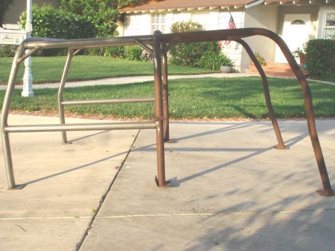 1977 Ford Bronco - A custom roll cage frame is shown on a sidewalk in front of a house.