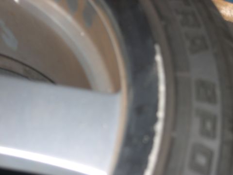 1997 Ford Probe - A close-up view of a vehicle's wheel and tire, showing details of the alloy rim and tire tread. Text from Supermotors.net is visible.