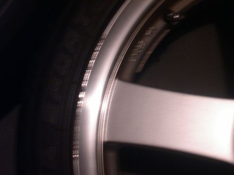 1997 Ford Probe - Close-up view of a car wheel and tire, with some text visible on the wheel.